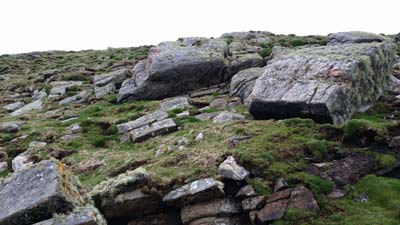 Looking up from the tramway at where Robert Muirhead stated that the box of ropes was located (beneath the large stone slightly above the centre of the picture). This is 110ft (34m) above sea level and is where Muirhead believed the men were swept away from.